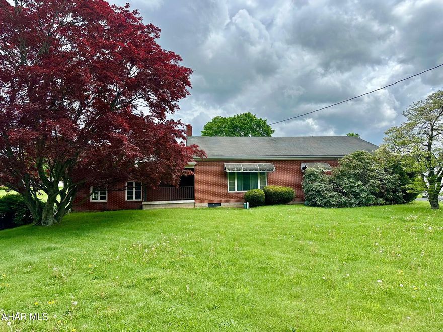 A wonderful setting for this brick ranch home situated on just under 1/2 acre just north of Everett, PA.  Original hardwood flooring was just uncovered in the living room and bedrooms and looks fantastic!  Main floor includes eat in kitchen, living room, flex room (den, office, or possible 3rd bedroom), 2 large bedrooms and a full bath.  Lots of storage with the attached 2 car garage, full basement, and large attic.   Great back yard, covered patio and original brick grill.  With some TLC this property will make a wonderful home.  Priced affordably at $139,900.
