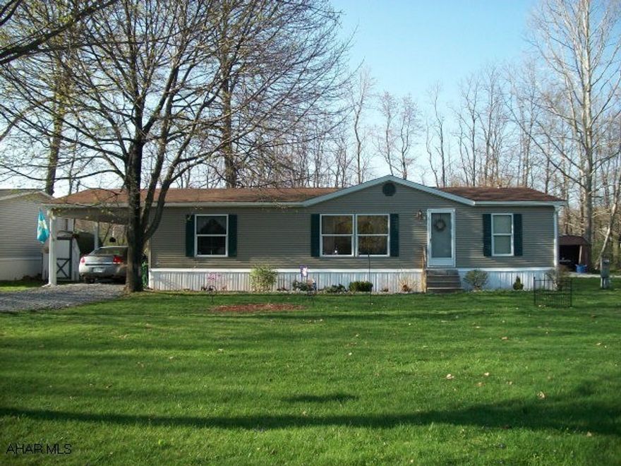 Very nice double wide located in quiet area, beautiful setting.  Convenient location.  Spacious, open floor plan with vaulted ceilings.  Newer central air system and carport with overhead storage.  Master bedroom has walkin closet and garden tub.  Lot rent only $250 - includes water/sewer and garbage.  No outdoor pets.  Landlord must approve buyer.