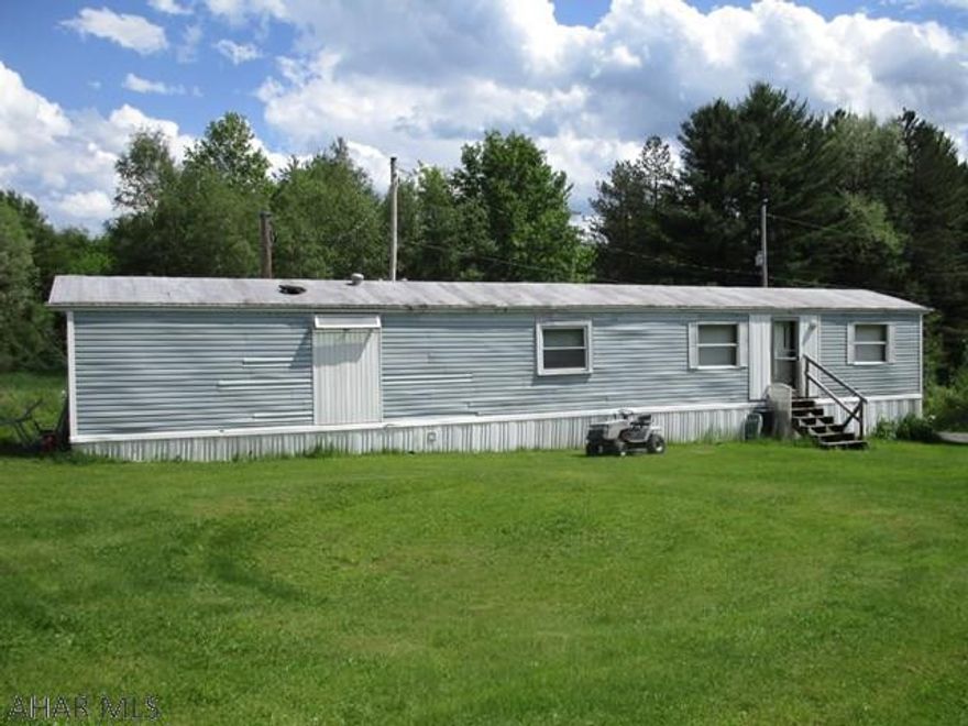 Well maintained and affordable mobile home on over 3/4 acre. Perfect for downsizing and 1 story living. Mobile home contains 2 bedrooms, full bath, kitchen, living area and laundry hook-ups. Looking for a fixer upper? Included in the lot is an additional 1 story house that could be flipped or made your own! House already has two kitchens, could be converted into a multi-unit investment property. Cash buyers ONLY.