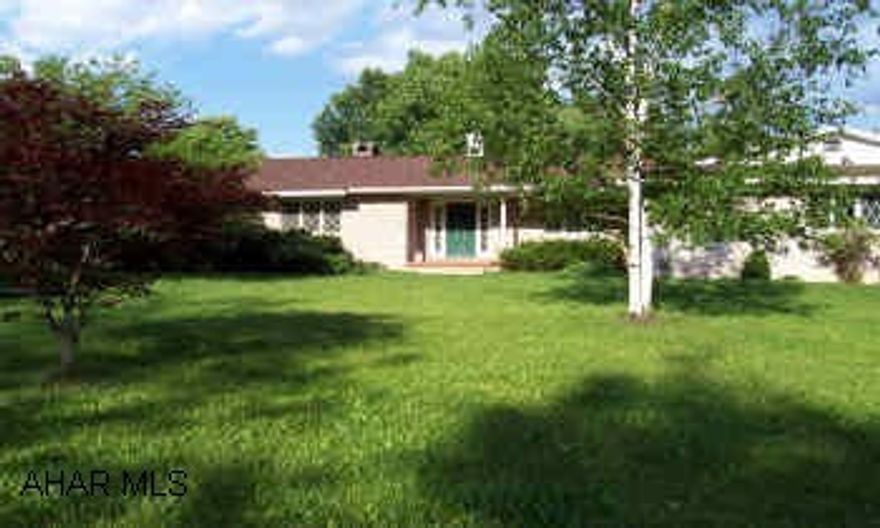 Country living on 3 acres. Beautiful ranch w/3BR, indoor pool, living room open into family room, double fireplace is beautiful! Cherry kitchen & more!!!  This property is private, wooded & includes 8 run dog kennel with its own out-building. There are many extras to this property! Lots of storage, central air, fenced yard, private patio & what a view!