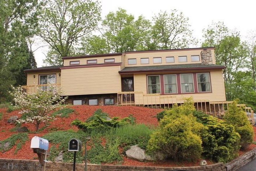 This Rolling Hills bi-level home has so much to offer!!!  3 possibly 4 bedrooms, 2.5 bath with the most fabulous view from any window or the decks.  The living room has a wood-burning fireplace with an open floor plan.  The dining area has a sliding door leading to the deck, overlooking the fenced yard.  The master bedroom has a sliding door with a small deck, walk in closet, vanity area and full bath.  On the lower level, you can find the full finished basement with bar area, pellet stove and new carpet!  Down the hallway you will pass the laundry room with 1/2 bath, with the possible 4th bedroom/office that also leads out to a deck. There is a full house generator included, vent-less microwave was installed above the range, skylights were removed, new roof and chimney was just completed.