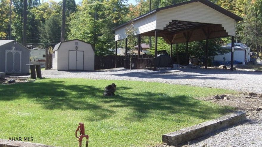 This is camping at its best.  Plenty of room for your camper under the pavilion will protect your investment.  This property consists of two adjoining campsites with two sheds to keep all of your outdoor equipment and leave you with lots of space for activities.  A fire pit area is ready for family campfires - who doesn't like to indulge in hot mountain pies?  These sites are located in Glendale Yearound, a gated community with activities for the whole family.  Swimming, playgrounds, basketball / tennis / volleyball courts are there for your enjoyment.  And if you bring your best furry friend, Poochie Park is not far away.  In addition, Glendale Yearound is adjacent to Prince Gallitzin State Park / Glendale Lake for fishing and boating enthusiasts. Rock Run ATV park is only 6 miles away.