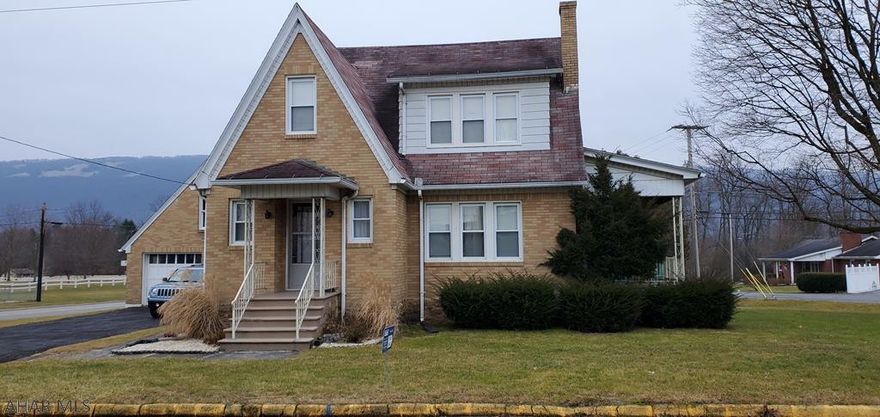 Bellwood Borough home with incredible curb appeal!  2 story all brick offering 3 bedrooms, 1.5 baths.  Hardwood flooring thru out the house.  Efficient gas hot water heat, covered porches, great 2+ car garage.  All of this on a large 0.40 acre lot!