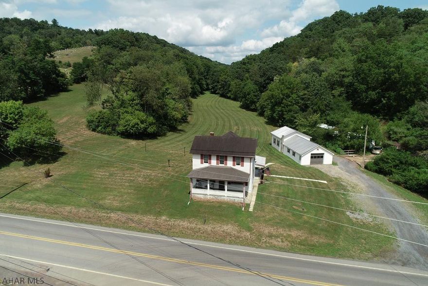 Imagine the joy in knowing that fishing and state game land is all within walking distance from this nicely renovated 3 bedroom farmhouse.  Relax on covered porches and enjoy a backyard that feels more like a park offering an amazing private setting on 7.5 +/- acres.  An oversized 6 car garage, workshop and nearby Raystown Lake makes this a must see home!