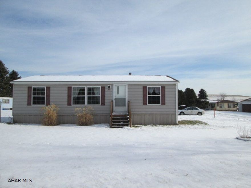 This mobile home is like new!  The kitchen features beautiful oak cabinets.  The carpet throughout the mobile home is in great condition.  The exterior has vinyl siding with a front and back porch.  The mobile home also includes a storage shed.  Lot rent is $185.00 a month.  Lot rent includes sewer, water, and garbage.  Must obey rented lot rules and regulations. Utilities have been turned off.  Could be moved to buyers own parcel of land at buyers expense.  Only minutes away from Prince Gallitzin State Park!
