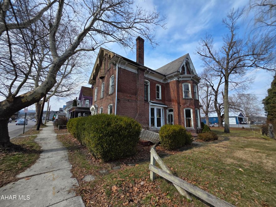 Brick triplex with distinctive interior details throughout. Features include a grand staircase with turned balusters, tall ceilings, decorative interior wood trim, hardwood floors, and a fireplace.
The property is configured as three residential units and offers spacious interior layouts with original design features still present. The structure provides an opportunity for renovation while maintaining the character of the property. It features 3 separate electric meters and off street parking.  Only minutes from i99 which makes commuting convenient. 
Property requires renovations and being sold as-is. Buyer to verify square footage, zoning, permitted uses, taxes, and lot size.