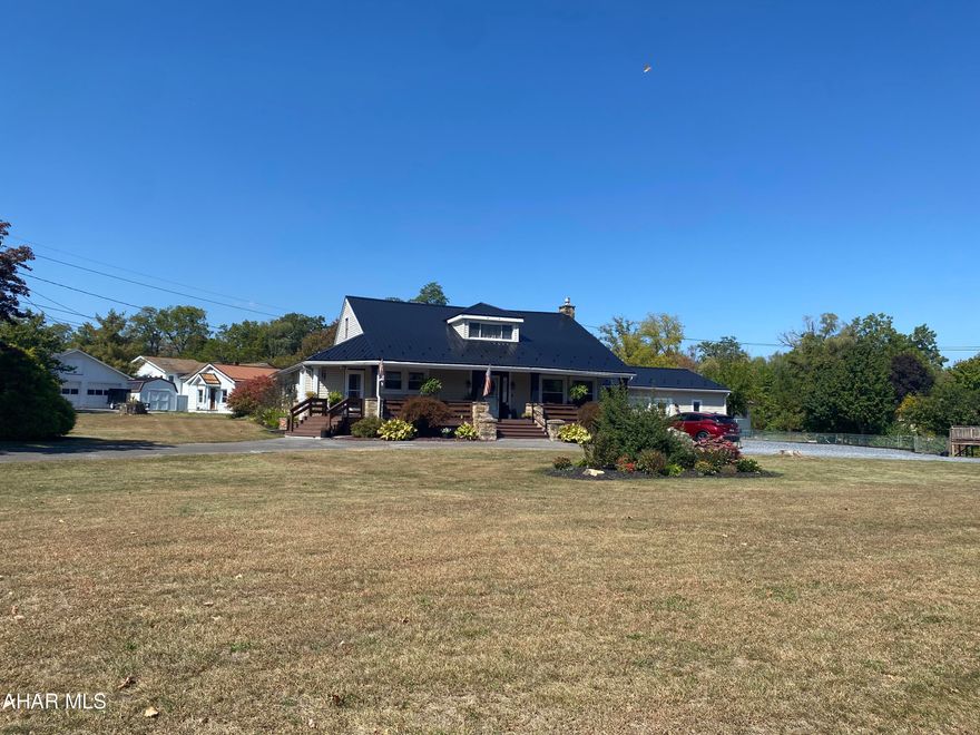 Welcome to this charming home situated on a spacious 0.7 acre corner lot in the borough of Duncansville. The property offers a large fenced-in yard, circle driveway, and plenty of parking - perfect for entertaining family and friends. Step inside to find an inviting eat-in kitchen with brand new appliances and  a convenient laundry area just off the kitchen. This home includes too many updates to list, but some substantial updates include a new metal roof, water tank, water softener, a brand new furnace, new water lines and paint throughout. Enjoy outdoor living with a large 48' covered front porch plus two additional decks through the sliding glass doors leading to the backyard. The main level features two generous bedrooms, a den or bonus room and a full bath. While the upper level boasts a third bedroom, a bonus room complete with beautiful exposed wooden beams and an additional bathroom that is a must see! A 1-car garage with an extra stall for storage, workshop or hobbies completes this property. best of all isn't not in a flood zone - giving you peace of mind. This home has space, charm and functionality all wrapped into one - don't miss the opportunity to make it yours!
