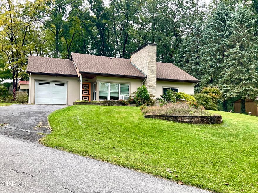 Peaceful SINKING VALLEY! It's like being on Vacation Everyday! This Sweet Home offers 3 BR, 1 Bath, Beautiful floor to ceiling Gas Fired Stone Fireplace in LR, with a Loft Family Rm. The Bathroom has been remodeled with a Ceramic Tile Walk In Shower & New Vanity. The Master Br is equipped with a Sink/Vanity! Off the Kitchen step out on to your Covered Patio to relax and cook out. Large Semi Finished Basement with high ceilings and a Wood Burning Stove for heat. Outside you have two Sheds and a Lg 2+ Car Carport! 
New Roof in 2021 and Newer Furnace. Move right in and make this piece of Heaven your own.