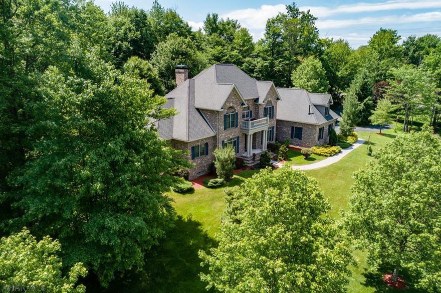 This LUXURY, 5 bedroom, 6 bath home is only 7 miles to Altoona!  It is located in a quiet and wooded neighborhood and landscaped with many exotic trees and evergreens.  The brick patio and pergola provide for wonderful outdoor entertaining.  Features include:  circular driveway, open floor plan, 2-story great room, elegant formal dining and living rooms, 2 gas fireplaces, glamorous catwalk, 2 first-floor bedroom suites, first-floor laundry room, custom window treatments, fantastic chef's kitchen, and hardwood floors.  The second floor has 3 bedrooms and 2 bathrooms.  The basement has an enormous office, a workout room, a theater room w/surround sound, and a half bath.  I have been selling real estate since 1999.  This is one of the nicest homes I have ever seen.  You'll love it!