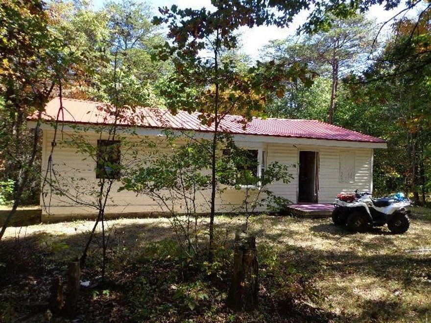 2-bedroom hunters retreat on 10.0 wooded acres. Includes all furnishings and tree stand. 1-story dwelling has 200-amp service, T & G oak ceiling in kitchen, dining & living area, and 1/2-wainscot & dry wall.