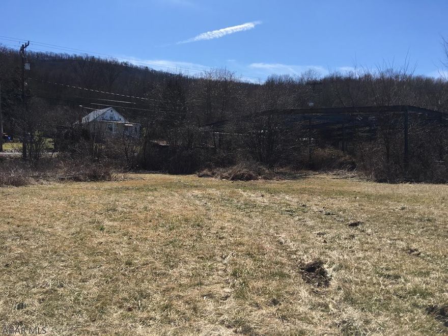 The property is flat and wooded with great road frontage along Rt. 96 S (Hyndman Road) on both sides of the road.  Great for a business or housing provided approval from the Manns Choice Borough.  The property use to be a saw mill, but no longer. Seller is not sure about the water and sewer hook ups.  Please call Manns Choice Borough authority for more information at 814-623-6252.  There is a Final Site Evaluation and Characterization Report Available for buyer.   Survey Available.  The tax assessment office says its 5.234 acres and the deed say 7 +/- acres and survey shows 4.6 acres.