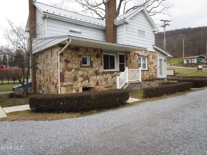 Nice two story home on corner lot moments from all amenities.  Large eat in kitchen with newer cabinetry.   Three bedrooms on second floor, bathroom on first floor along with laundry.   Hot water boiler is seven years old.  Mostly newer windows.  Well is still useable for gardening purposes.  Carlee Lane is deeded land to subject property and used by other property owners across stream.   Three car garage included - this was formerly a commercial working garage.  12' ceiling.  Has separate electric system, heat, water/sewer access.  Deeded lot extends across Mill Run stream.  PROPERTY IS BEING SOLD AS-IS.