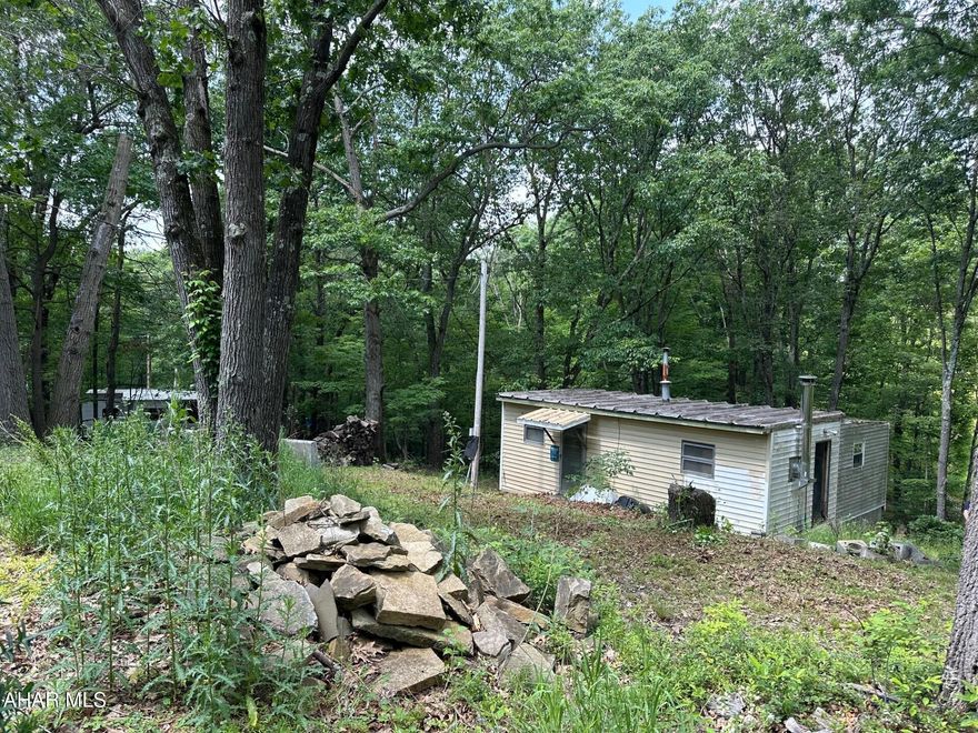 A get-away retreat who love the country!  Private, Wooded, Hunting, Fishing and wildlife!!   Gravel parking area.  No well or septic only Electric. RV welcomed!
Owner started to renovate the cabin.
AS IS WHERE IS