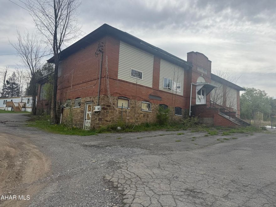 Former Flinton school with 5 mobile home pads.  Four pads currently rented at below market rates. The brick former school building was converted to apartment but needs near complete renovation. 2 acre site should lend itself to expansion of additional mobile home pads. With rents increasing since covid this would be an excellent opportunity for a good income source once finished.