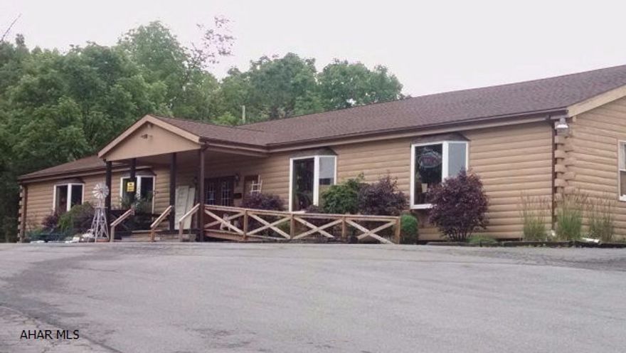 Location! Location! Prime business spot with tons of possibilities--- offices, retail shop, beauty salon/ spa, gym, pet shop, landscaping business, you name it --- whatever the commercial need! One story log building of approx. 5,000 sq. ft., with additional appx. 5,000  sq. ft.usable area of basement level. Cathedral ceilings, knotty pine walls and ceilings, hardwood floors on main level. Currently occupied by a resale shop utilizing both floors as their shop. Situated in front of motel 6, adjoining Orchard Plaza Shopping Center, only 2 blocks from Logan Valley Mall. Low taxes -- $2762.00 Situated on 1.72 acres in Logan Twp. Motivated Seller just reduced price  - What a great buy! Bring offers! Call listing agent for appointment. Taxes and square footage are an approximate.
