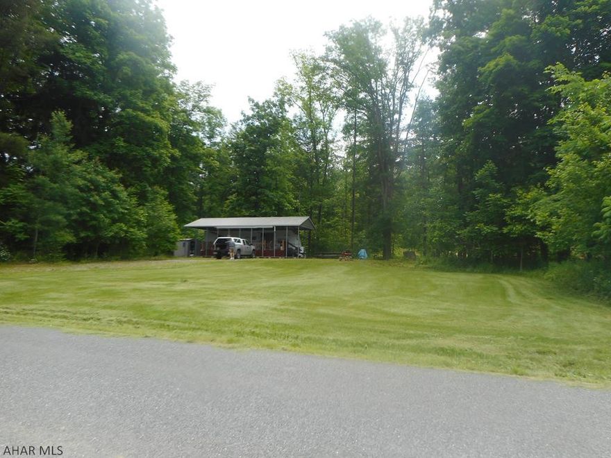 2009 Wildwood camper under metal pavilion on 1.3 Acres. Large deck. Public water and sewage hooked up. Lots of frontage. Camper in good condition. Located a few miles from Prince Gallitzin State Park and Rock Run Recreation area. Great country setting for your weekend getaways.