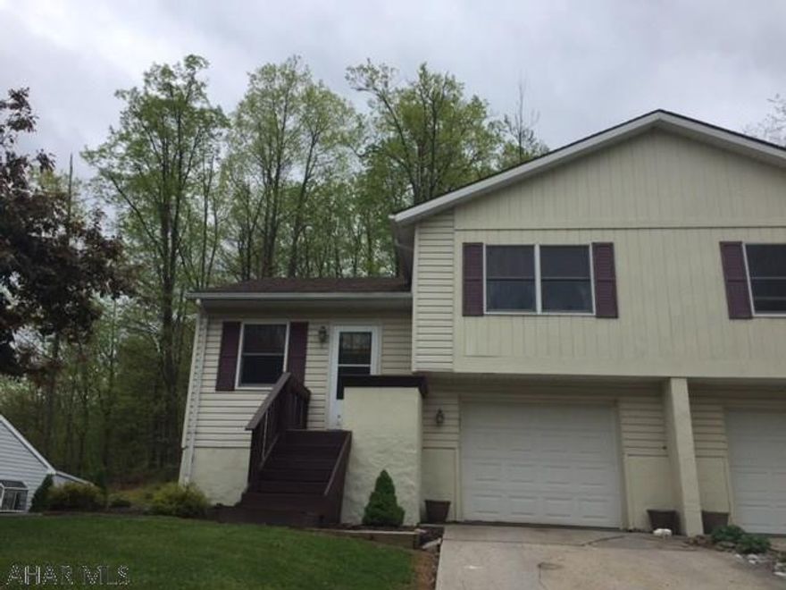 2 Bedroom, 1 bathroom half of a double home, electric baseboard heat. Finished basement. Integral garage. Ready to move in. Wooded setting.