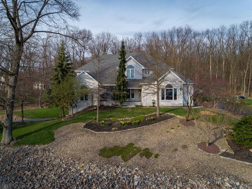 When this home was built, no detail was overlooked.  Grand foyer leads to a sunken dining room / living room and a home office, or 4th bedroom.  Continue thru to the beautiful kitchen that is open to a large dining area, a sunroom "niche" and large family room with 19 ft ceilings, fireplace, wet bar and floor to ceiling windows.  Off the family room is a screen porch, a great place to watch the birds and wildlife.  The master bedroom opens to a lovely bathroom with a large his and hers walk in closet.  The 2nd and 3rd bedrooms share a Jack and Jill bathroom and all upstairs bedrooms are open to a catwalk with views to the family room.  2 driveways, each with their own garage.  Lower finished level could easily be used as a inlaw suite.  See link for video tour!