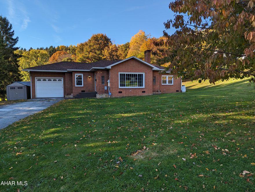 This updated, brick, one-story home sits on over a half acre, corner lot in Northern Cambria.  When the snow starts to fall, you can warm up beside the propane fireplace in the large living room.  During the summer months, you'll enjoy the lighted ceiling fans and the central a/c.  The spacious kitchen/dining area has tile floors, lots of cabinets, ample counter space, and a door that leads to the large back deck. All of the kitchen appliances are included. The bedroom located on the left of the house has an adjoining 3/4 bathroom.  On the right side of the house, there are 2 more nicely-sized bedrooms and a full bathroom.  The living room and the bedrooms have new laminate floors.  The laundry area is located just off the large, 1-car garage.  What I think you'll really like about this house is that it is very bright inside.  Studies show that natural light can improve energy efficiency and your psychological well-being.  Come see for yourself.   Call soon to schedule a private tour.
