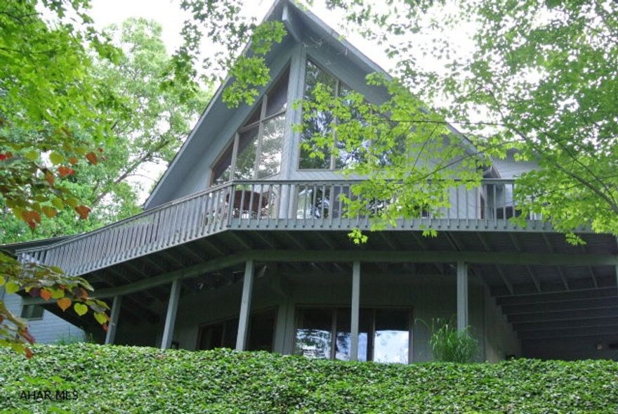 Spacious A-frame in Hollidaysburg School District. 3 BR, 3.5 BA, sunny LR features Brazilian Cherry floors, custom drapes and a vaulted ceiling. Kitchen was remodeled and now boasts granite c-tops, tile floors, dual fuel stove & new sky lights w/shades. Enjoy mornings on the screened-in porch - always a breeze thanks to the ceiling fan. Master BR w/FP, access to deck and a vaulted ceiling. Master bath has been updated w/travertine tile, jetted tub, new vanity & glass shower. FR has a new Heatilater FP that keeps it cozy in the winter. Also a kitchenette in the lower level - perfect for entertaining. A new roof was just installed and the exterior has been painted...nothing left to do but move right in! This home has a private setting with numerous perennials & trees. A rare setting!