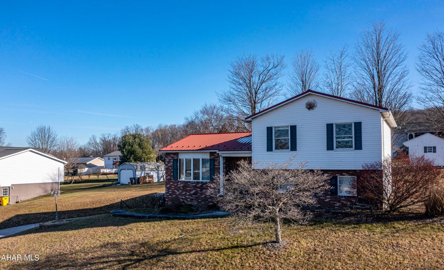 Nestled at the end of a cul-de-sac, this 3 bedroom, 1 bath multi-level home awaits your personal touches! The spacious master bedroom offers a walk-in closet.  The unfinished lower level could be made into a large recreation room, master suite, or even more bedrooms and baths with roughed in plumbing already present. Outside features include a newer metal roof, large covered patio perfect for outdoor gatherings or a quite retreat, a shed for additional storage, and beautiful views! Don't miss out on the opportunity to own this home! The potential is truly endless!