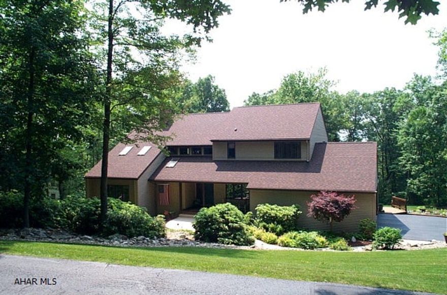 Elegance found in this 3100 sq ft custom built 4 bedroom, 3.5bath contemporary situated on an .8 acre wooded lot. Oak cabinetry and trim throughout. A two story foyer leads to the formal dining room or to the sunken living room with oak floors, vaulted cedar ceiling, skylights and 2 sided see thru fireplace. The adjacent family room shares the fireplace and has wet bar.  Newly remodeled eat-in kitchen with center island and JennAir cooktop. Eating area with multiple doors leading onto the screened room or multi level deck.  The 2 nd floor offers a spacious master suite, 3 addl bedrooms and an upgraded bath. The lower level includes a finished rec room(walk-out)with bath, storage areas, cedar closet and mechanics room.