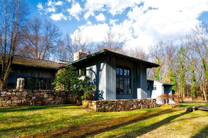 Prestigious Sylvan Hills home located on a 3.7 acre wooded, private lot. The exterior stone was taken from a quarry in PA, the floor tiles are Mexican terracotta, Brazilian Walnut graces many of the walls and the front of the Bar is an Italian import, look outside to see the Egyptian artifices embedded in concrete, this home is truly steeped in culture and history. SS kitchen with solid copper, patinaed backsplash, Sub-Zero ref/freezer. 4 Bedroom suites with their own private stone/travertine Baths.  Media room is situated away from the main flow, it could transform into a private in-law/guest suite.  Lower level boasts a family rec rm, Sauna, full bath and another BR, all this opens up to the rear yard w/Gazebo and a fire pit, enjoy!  2 add'l,  adjacent lots maybe purchased separately.