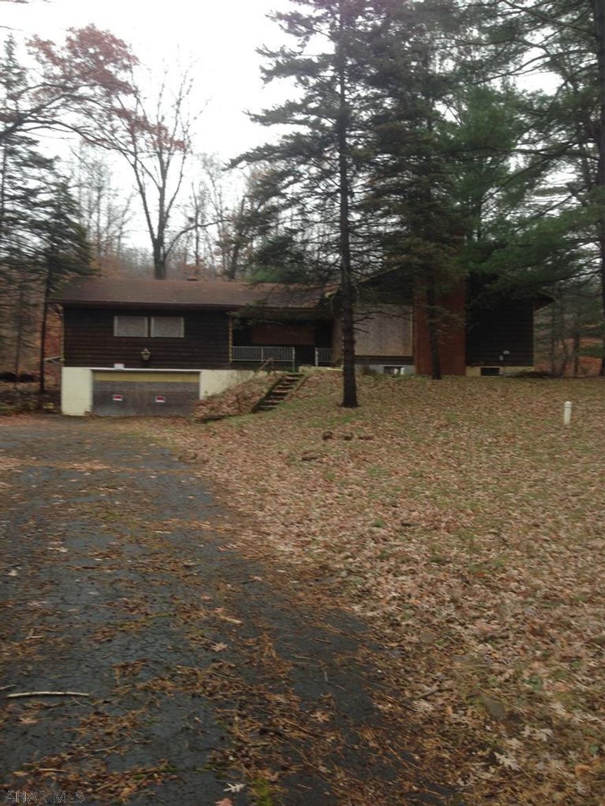 Large raised ranch with 2 car garage on 5.87 acres. Will need a lot of updating but great investment.