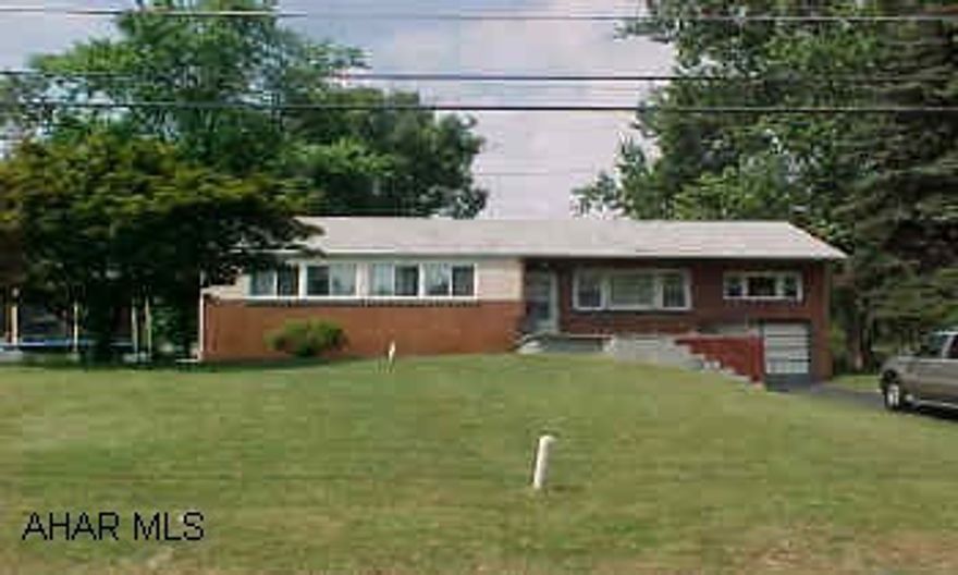 Solid home on great wooded lot in West Loop. One car garage. Home has hardwood floors. Family room above garage.