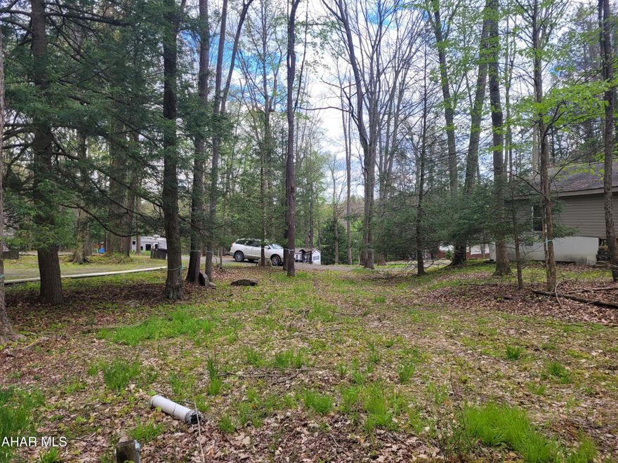 Here is a private wooded campsite to place your camper.  Public water and sewer are on the lot.  Electric service is present.  It will need inspected.
This lot is located in Glendale Yearound.  Join the activities, swim at the pool, play tennis, horseshoes or stop at the playground with the kids.  Take the dog to Poochie Park.  All of this adjacent to Prince Gallitzin State Park / Glendale Lake, six miles from Rock Run ATV Park and close to State Game Lands.  If you love the outdoors and are looking for a place for your camper come take a look.