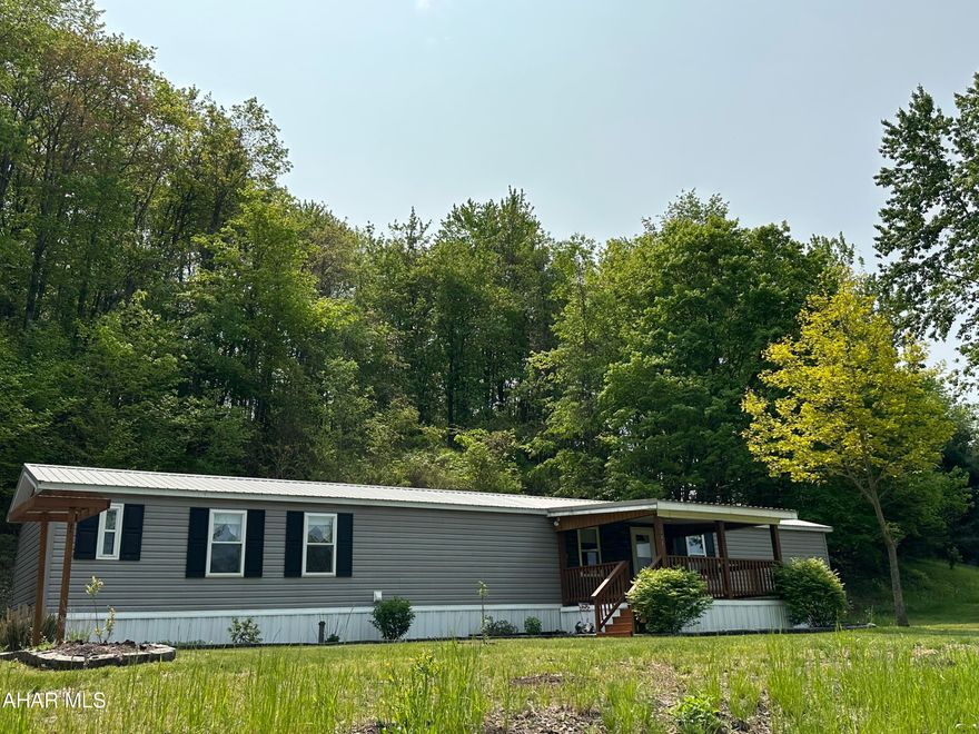 Beautiful updated mobile home in a country location.  Move right in!  This property features a spacious living room open to a great kitchen with center island and eating area.  Great floor plan! Relax on the front and rear covered porches.  The two car garage has plenty of space!