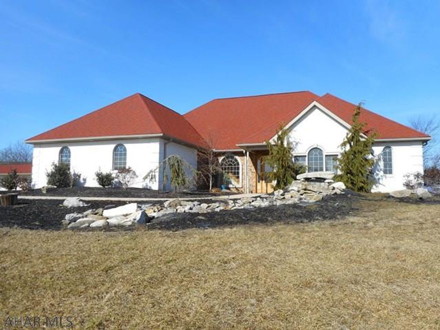 This quality 4 bedrm, 3.5 bath brick home has an incredible view with 5.5 acres yet minutes from Holbg. This home boasts 10ft. ceilings, 8ft solid wood doors, hardwood & ceramic floors throughout.  Beautiful  crown moulding. Maple cabinetry compliments the granite counters, island with cooktop & breakfast bar.  Radiant heat in the floors makes for a cozy winter evening in front of the stone fireplace. lst floor laundry and mud rm. 2nd floor spacious family room plus bonus room. Beautiful spiral staircase with hardwood steps.  Outside amenities include a 30x60 detached garage/workshop. . Large concrete patio with fire ring . Beautifully landscaped with waterfall. Please see video.