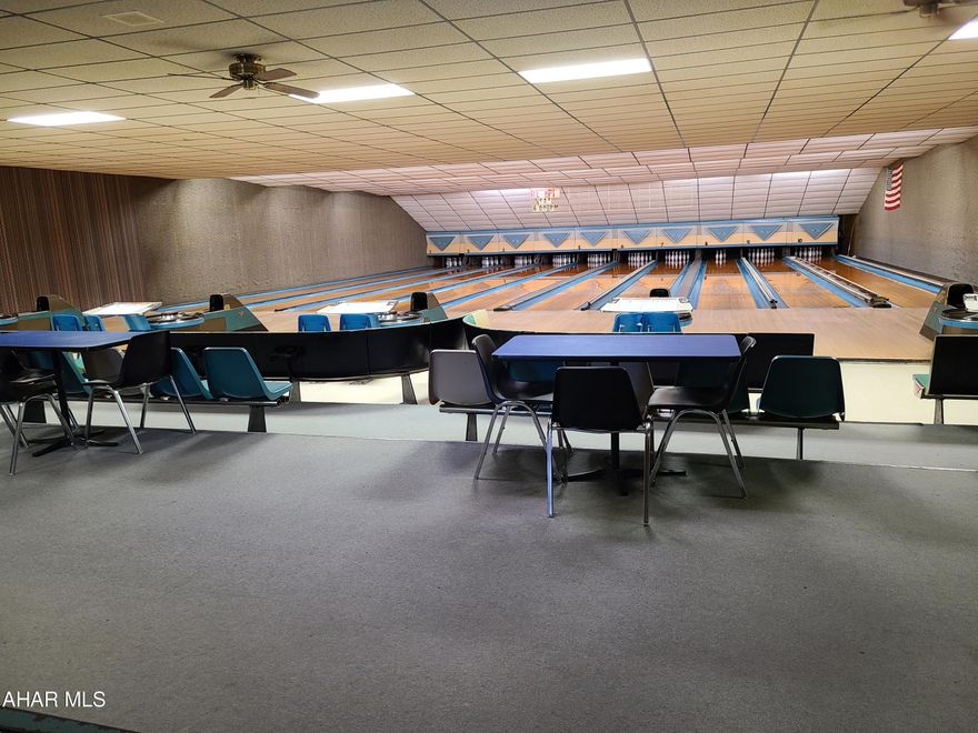 Large, 1-story commercial building on the main drag in Ebensburg - across the street from Lake Rowena. This property has been operating as a bowling alley since 1960. Slab foundation, 8520 sf, large parking area, public water & sewer. Keep it as a bowling alley or convert it to a business of your choice. The possibilities are endless.