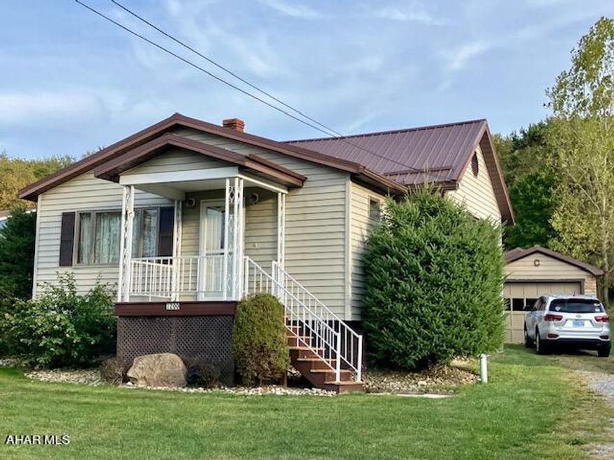 This ranch home in Washington Twp (Penn Cambria School District) is situated on nearly 1/2 acre lot; it's a great place for entertaining w/ a nice sized garage, 2 sheds, & an outbuilding previously used as a music studio. There is also a carport perfect for outdoor gatherings. Key highlights are A/C, ,a beautifully designed kitchen w/ ample cabinetry, durable metal roof, 2 nice sized bedrooms & one & a half bathrooms all on 1 level. From the back door you'll be welcomed by the cozy kitchen, then a generous living room, & easy access to the front entry room w/ lots of natural light. The house has a full bathroom near the front entrance & one near the backdoor. The unfinished basement offers plenty of storage and laundry hookups.