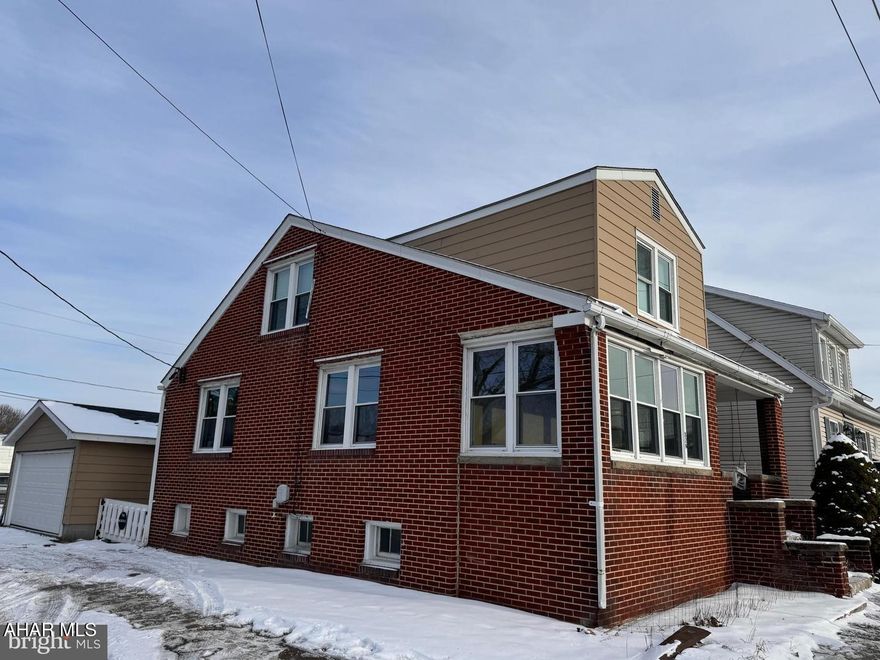 Discover affordable homeownership with this delightful 3-bedroom, 1.5-bath home, offered at an incredible $129,500! Bursting with charm, this home is ready for you to personalize and make your own. The spacious first floor features an open kitchen and dining area, ideal for hosting gatherings, along with a cozy eat-in kitchen for everyday meals. The heated, enclosed front porch offers a perfect spot for a home office or relaxation year-round. Upstairs, you'll find three bright and inviting bedrooms with beautiful hardwood floors and a full bath. Outside, enjoy the ease of a small, fenced yard designed for low-maintenance living. The 2-car garage has been thoughtfully reimagined as a versatile recreational space, perfect for entertaining or pursuing hobbies. Why rent when you can own? This is your opportunity to invest in your future and start building equity. **SELLER ASSIST OR ROOF CREDIT AVAILABLE WITH AN ACCEPTABLE OFFER.** Schedule your tour today and take the first step toward homeownership!