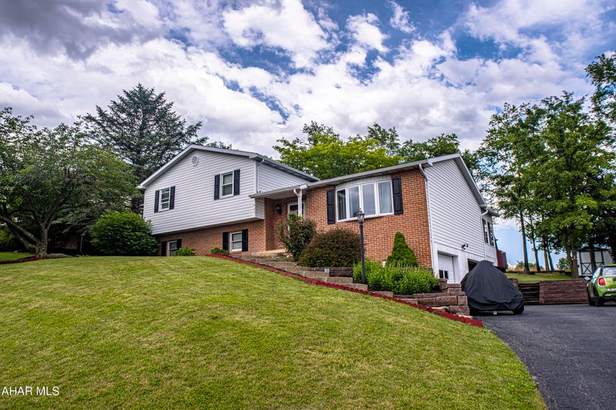 Public Remarks: This is a move-in ready and updated split level in the Rolling Hills Estates of Hollidaysburg.  Check out the spectacular views of the mountains from this elevated hill position. Master bedroom has ensuite for added privacy.  The updates include new carpeting and flooring throughout, even in the spacious sunroom.  Kitchen has all new Maytag stainless steel appliances, as well as washer and dryer.  Furnace was replaced just this year.  Two of the bathrooms have been remodeled and the back deck has been replaced.  Very private back yard and all new landscaping as well.  And the hot tub is included.