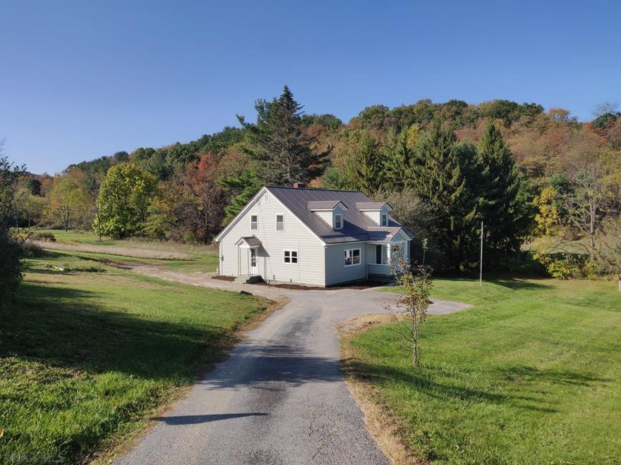 Great Spot in the Country on Roomy Lot in East Freedom, but Close to Everything. Large 4 BR 1 Bath with 2 Car Garage on 1.8 Acres. Huge Living Room with Fireplace, 2 First Floor Bedrooms, 2 Second Floor Bedrooms, Large Tall Walkout Basement for Shop or Rec Room. Plenty of Land for Animals or Gardening! Some Wood Floors, Metal Roof, Low Taxes, Spring Cove School District. Could be One Floor Living if Desired. Agent Owned.