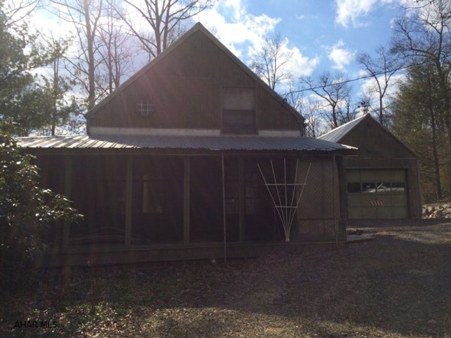Quaint 2 bedroom, 1.5 bath cottage with wrap around porch, laundry room and is located next to State Game Lands with garage, shed and 20' x 40' pole barn on 1 acre! This well built home would be the perfect get-away weekend home for the hunter or fisherman, or it could be a nice year round home. The pole barn has a concrete floor, perfect for storing boats, 4 wheelers or possibly an RV. Easy access to the PA Turnpike and Interstate 70.