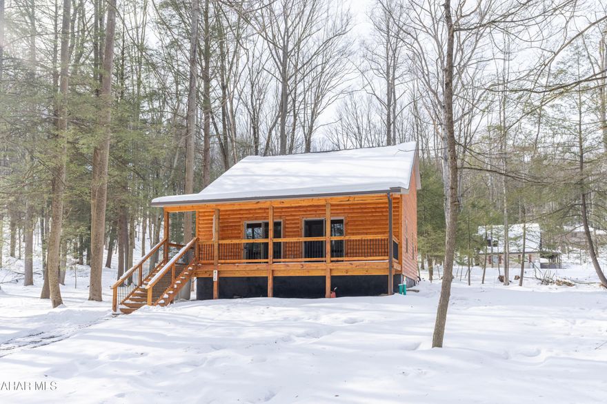 COMFY CABIN ON CROSSCUT: This beautifully crafted 3-bedroom, 2-bath log cabin home was just built in 2024 & is located in the gated Glendale Yearound Community near Prince Gallitzin State Park.  This stunning home offers rustic charm, modern efficiency, and access to exceptional recreational amenities both in the secure, gated community & in the natural surroundings closeby.   Community amenities including a pool, playground, tennis courts and more—plus easy access to boating, fishing & swimming at the lake or hunting & hiking on State Gamelands. You name it, it's nearby!  Perfect as a full-time home, weekend retreat, or year-round base camp for outdoor fun.

Relax on the inviting front porch before stepping inside to a soaring vaulted ceiling and an open-concept living area. The main level features a convenient first-floor bedroom and full bath, perfect for guests or easy one-floor living. Upstairs, you'll find two additional bedrooms connected by a Jack and Jill bath, offering comfort and privacy.

Designed for year-round enjoyment, the home includes an energy-efficient heat pump  for heat and central A/C (along with propane backup for added peace of mind).  The full basement was professionally waterproofed in 2025. Tucked along a private road with peaceful wooded surroundings, you'll enjoy abundant wildlife including deer and turkeys right from your property.

Whether you're seeking a full-time residence, weekend retreat, or outdoor enthusiast's dream property, this essentially brand-new log cabin delivers the perfect combination of comfort, privacy, and unbeatable access to Pennsylvania's premier recreation areas.  Schedule your showing today!
