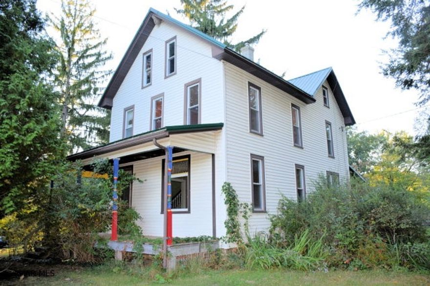 Beautiful setting for this farm house with two car garage.  Some work has been done to the interior and it will be worth the effort to finish the job. New roof.  Newer vinyl siding and windows.  Acreage is partly wooded.  Some open fields.  Property is being sold As Is.
