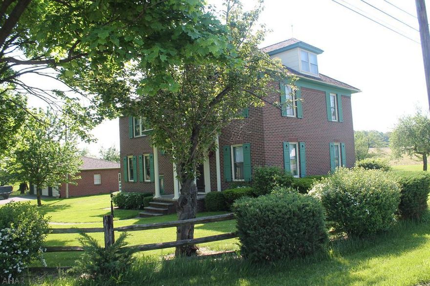 Dignified large 5-bedroom brick colonial in the picturesque Martinsburg area. This home includes walk-up attic and a 3-car garage with plenty of room for storage or your hobby needs. Property also includes fruit bearing trees and grape arbors. This home contains large bedrooms and a 13.2x8 breakfast nook. Enjoy the beautiful views in the evenings on the covered porch. House is situation on over an acre of land in a private country setting while remaining conveniently located close to shopping needs in Roaring Springs and Martinsburg. MOTIVATED SELLER!!!!!