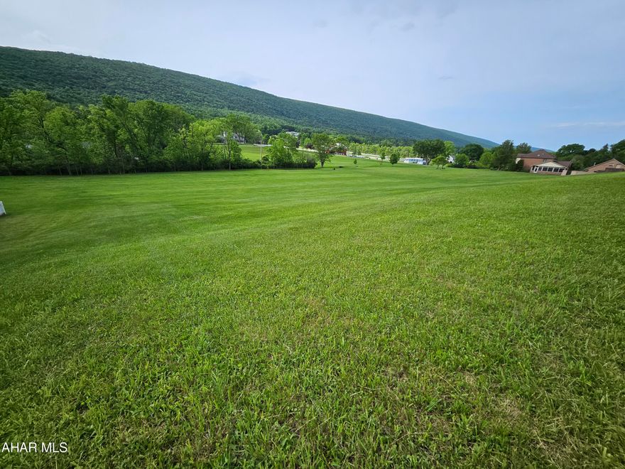 Tremendous opportunity in Scotch Valley Estates development!  5.23 acres within the first development off of Frankstown Road!  This property features a long paved driveway  that leads to a graded foundation.  The lot already has established underground electric service with hookups, a private well, a septic system with 2 newer 1000 gallon concrete tanks and rebuilt retaining walls and patio with landscaping that surround a 33,000 Grecian inground pool!  With all of the mechanics and grading done - this prime acreage is ready for your dream build - with the pool as a huge bonus!