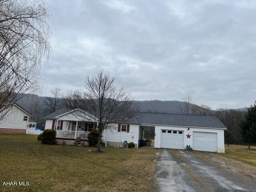 Nice doubleiwde on private flat lot in claysburg.  Large eat in kitchen opens to living. Master bedroom with private bath that has access to rear deck. Large oversized two car garage