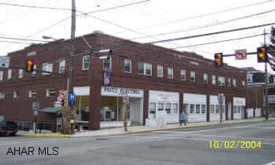 brick commercial building with large office space and corner show room.  7 apartments with downtown location. and 12 off street parking places
