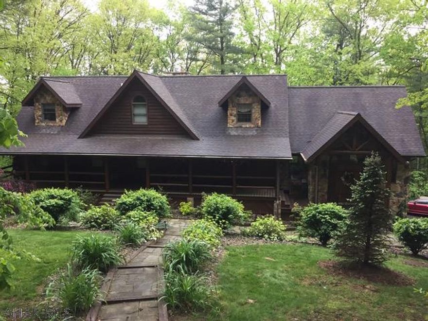 This home will wow you the minute you walk through the door. A beautiful log home nestled on a secluded lot in Shenecoy Manor, minutes to town, shopping, and Raystown Lake. The perfect home away from home or your forever home. As you walk through the door you enter a large great room with cathedral beam ceiling & wet bar.  Kitchen has Stainless steel appliances, granite counter tops and open concept to the living, great room, and dining area. Enjoy the convenience of a First floor master suite. Mother-in-law suite or guest quarters on lower level with family room, bedroom, full bath, game area, and also plumbed for a future kitchen area, utility area w/work bench and large laundry room.  The deck spans the back of the home and gives the feel of being in a tree house surrounded by nature.