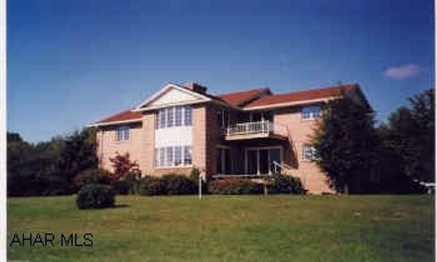 Gracious front gabled 2 story brick on hilltop with panoramic view, and professional landscaping oil, coal, wood furnace, 2 heat pumps, central air, central vac., 2 view decks, patio,