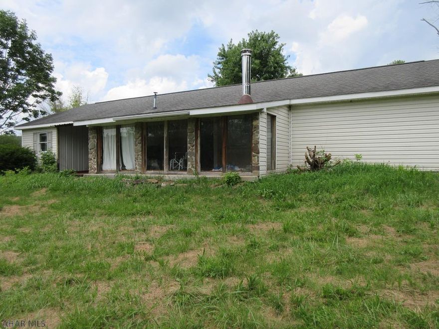 1 story home on 3.93 acres just off I-99 Imler exit. Loads of possibilities, but needs TLC throughout. AS-IS sale. Seller will make no repairs. Mobile home on property is extremely old. Make, model, serial number, etc. is missing/unknown. Mobile home cannot be used with existing on-lot sewage system as it is illegally taped onto system of house.