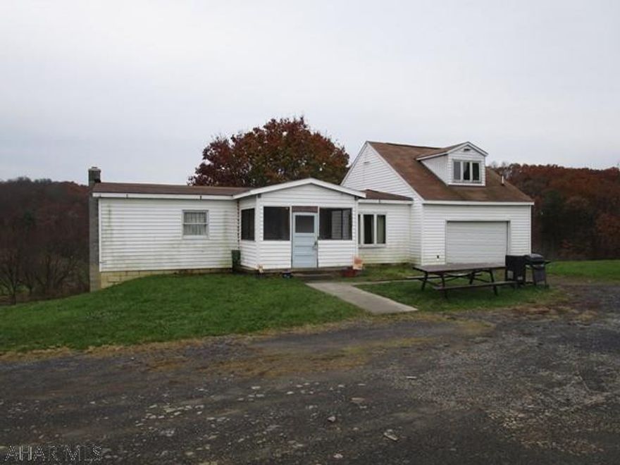 This home offers a living room, kitchen, family room, three bedrooms and two full bathrooms.  It rests on a full basement, has a one-car attached garage and three-car detached garage.  Newer oil forced air heat, central air-conditioning, 200-amp electric, private well and private septic.  Nice large spacious lot containing 4.4 acres with scenic country views.  This is a manufactured home with a stick built addition.