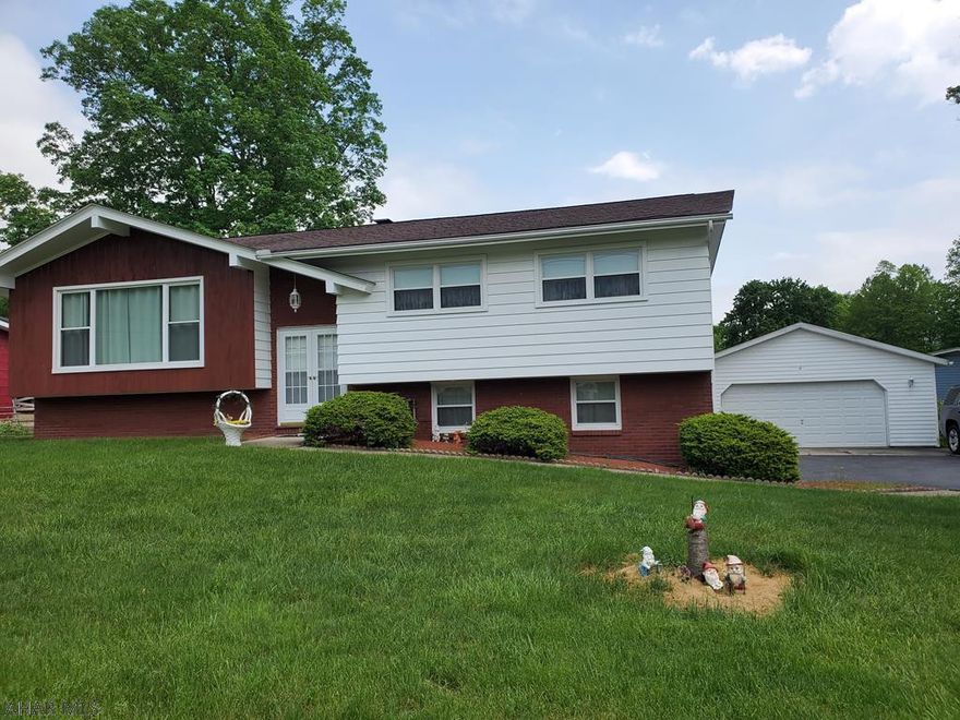 Nicely maintained Bi-level. Spacious living room and bonus family room. 3 bedrooms, 1 full, 1-3/4 bath and 1-1/2 bath. 4 car garage, storage shed, huge lot.  Gas hot water heat and central air, public utilities