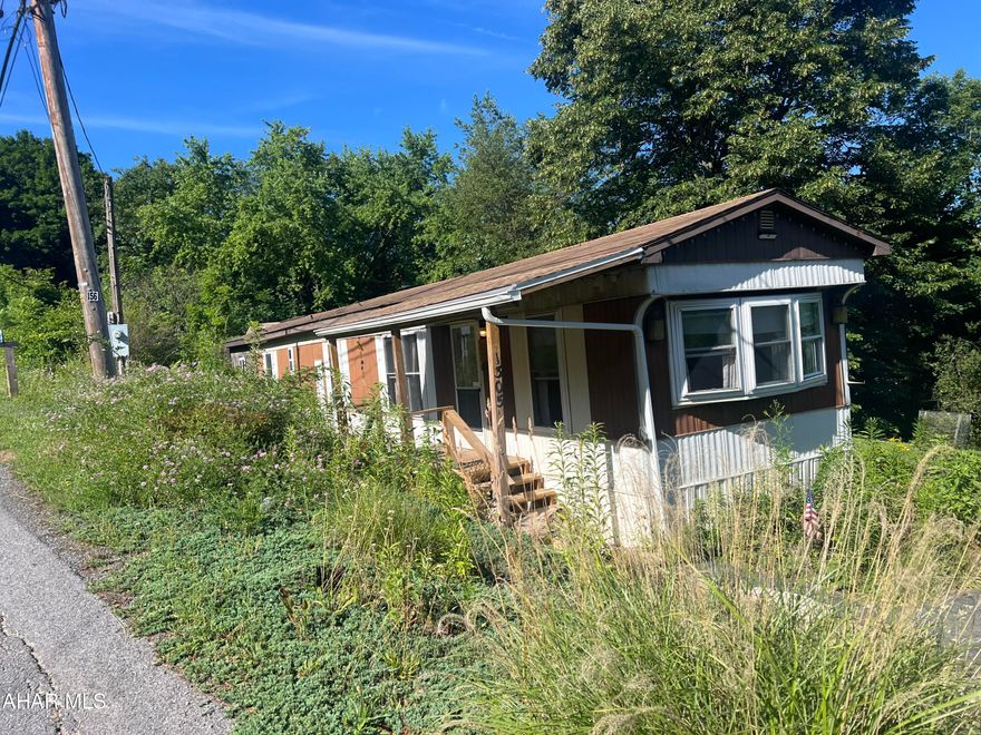 Mobile home with addition featuring nice eat in kitchen with range and refrigerator, living room, 2 bedrooms, office and 1.75 baths. Newer FA oil furnace and central air. Large screened in rear porch. Three sheds and over 0.7 acre lot.